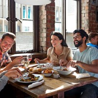 friends enjoying a meal - food stockfoto's en -beelden