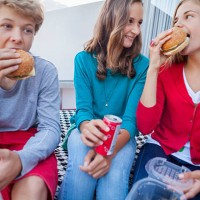 friends enjoying fast food together - junk food stock pictures, royalty-free photos & images