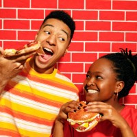 friends enjoying pizza and burgers together - junk food stock pictures, royalty-free photos & images