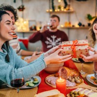 friends exchanging christmas presents - food stock pictures, royalty-free photos & images