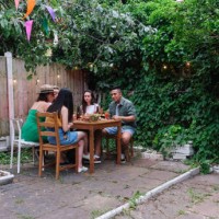 friends gathered in backyard for party - garden decoration photos et images de collection