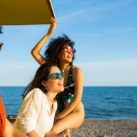 friends hanging out at the lifeguard station on the beach - travel stock pictures, royalty-free photos & images