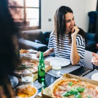 friends having a pizza at home - junk food stock pictures, royalty-free photos & images