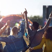 friends having arms in the air in front of stage - concert stock pictures, royalty-free photos & images