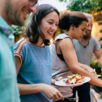 friends having summer barbecue together line up for food - food stock pictures, royalty-free photos & images