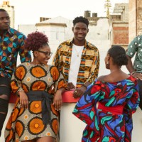 friends in colorful clothes on roof terrace in the city, maputo, mozambique - fashion stock pictures, royalty-free photos & images