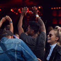 friends laughing at concert, arms in air - concert stock pictures, royalty-free photos & images