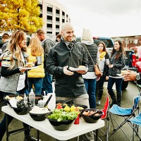 friends putting condiments on burgers during party - food stock pictures, royalty-free photos & images