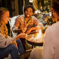 friends roasting marshmallows at back yard - garden decoration stock pictures, royalty-free photos & images