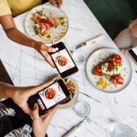 friends sharing food photography fun - food stock pictures, royalty-free photos & images