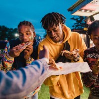 friends sharing pizza at festival - junk food stock pictures, royalty-free photos & images
