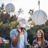 friends smoking and drinking at a party - garden decoration stock pictures, royalty-free photos & images