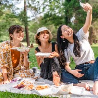 friends taking selfies while enjoying having picnic in nature - junk food stock pictures, royalty-free photos & images