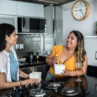 friends talking and eating asian food at home - junk food stock pictures, royalty-free photos & images