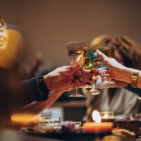 friends toasting with a glass of wine during a dinner celebration - food stockfoto's en -beelden