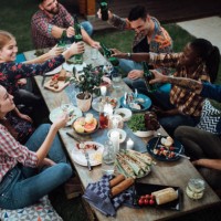 friends toasting with wine and beer at rustic dinner party - food stock pictures, royalty-free photos & images