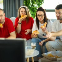 friends watching a game at home. - junk food stock pictures, royalty-free photos & images