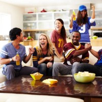 friends watching football in living room - food stock pictures, royalty-free photos & images