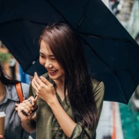 friends with umbrella laughing - junk food stock pictures, royalty-free photos & images