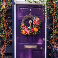 front door and shutters adorned with floral decor - garden decoration stock pictures, royalty-free photos & images