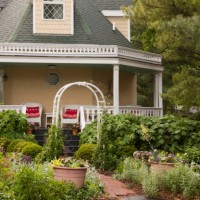 front porch with ice tea and wicker furniture overlooking gardens - garden decoration stock pictures, royalty-free photos & images