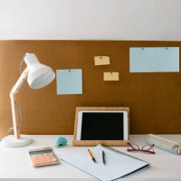 front view image of a study area in a girl's or teenager's room with a desk with study material for homework, and a cork board with map. - home decoration stock pictures, royalty-free photos & images