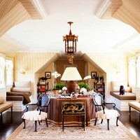 front view of a big lamp placed on a round table with books, plants and statuettes arranged around it - home decoration stock pictures, royalty-free photos & images