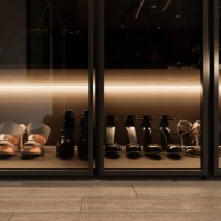 front view of a group of women's heels on a shelf with glass doors in a room in the foreground. - fashion stock pictures, royalty-free photos & images