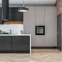 front view of a modern high black and gray kitchen with rectangular black and white marble breakfast kitchen island and brick wall background - garden decoration stock pictures, royalty-free photos & images