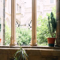front view of a window inside a hotel with two vases and a garden in the background - garden decoration stock pictures, royalty-free photos & images