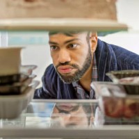 frowning man looking food - food stock pictures, royalty-free photos & images
