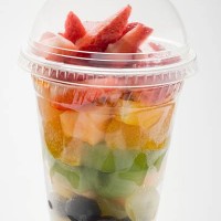 fruit salad with strawberries in a plastic beaker - junk food stock pictures, royalty-free photos & images