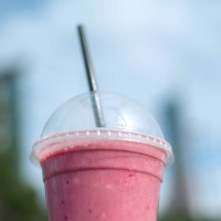 fruit smoothy in plastic take away cup over city background - junk food stock pictures, royalty-free photos & images