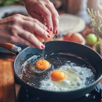 frying egg in a cooking pan in domestic kitchen - food stock pictures, royalty-free photos & images