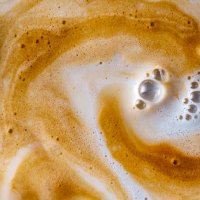 full frame of cup with milk and coffee in motion are mixed. - coffee stockfoto's en -beelden