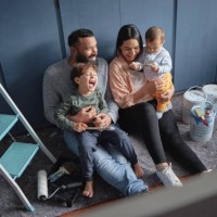 fun family renovating diy home improvements and painting new property together. above view of mother, father and children bonding. having fun, laughing, redecorating, designing purchased real estate - home decoration stock pi