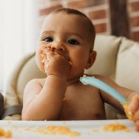 funny baby eating healthy food on kitchen - food stock pictures, royalty-free photos & images