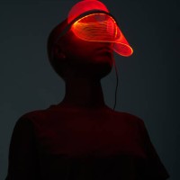 futuristic sot of young woman wearing led beauty mask with red lights over dark background - fashion stock pictures, royalty-free photos & images