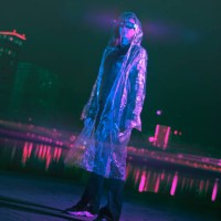futuristic woman standing on a street in neon city at rainy night - fashion stock pictures, royalty-free photos & images