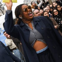 Gabriella Karefa-Johnson is seen wearing a blue coat, gray Miu Miu top, blue skirt outside Miu Miu show during the Womenswear Fall/Winter 2025/2026...