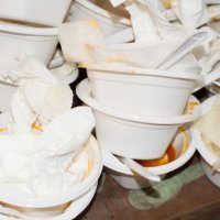 garbage can overstuffed bin with plastic plates and forks - junk food stock pictures, royalty-free photos & images