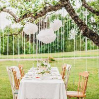 garden party arrangement with decorations hanging from tree. - garden decoration stock pictures, royalty-free photos & images