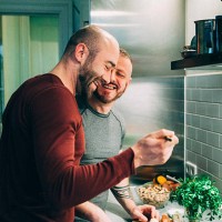 gay couple preparing the meal in the kitchen - food stock pictures, royalty-free photos & images