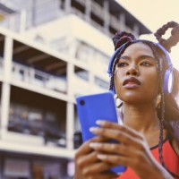 gen z woman, music phone and city street fashion, trendy style and cool attitude influencer. hipster black girl listening to audio with headphones, social media apps and unique urban youth lifestyle - fashion stock pictures, 