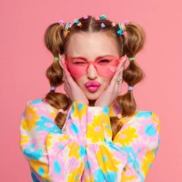 gen z young woman with stylish hairstyle against pink background - fashion stock pictures, royalty-free photos & images