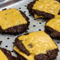 General picture shows grilled cheeseburgers at Meat Crew fast food restaurant on May 28, 2023 in Milan, Italy. On occasion of the World Burger Day,...