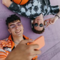 generation z friends hanging out together outdoors in the city, spending time online. - fashion stock pictures, royalty-free photos & images