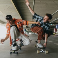 generation z friends riding skateboards in parking garage. - fashion stock pictures, royalty-free photos & images