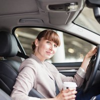 germany, hesse, frankfurt, portrait of smiling businesswoman with coffee to go sitting in her car - junk food stock pictures, royalty-free photos & images