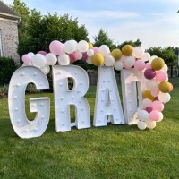 Giant light up Grad sign with Balloons in front of home during graduation season, Virginia.